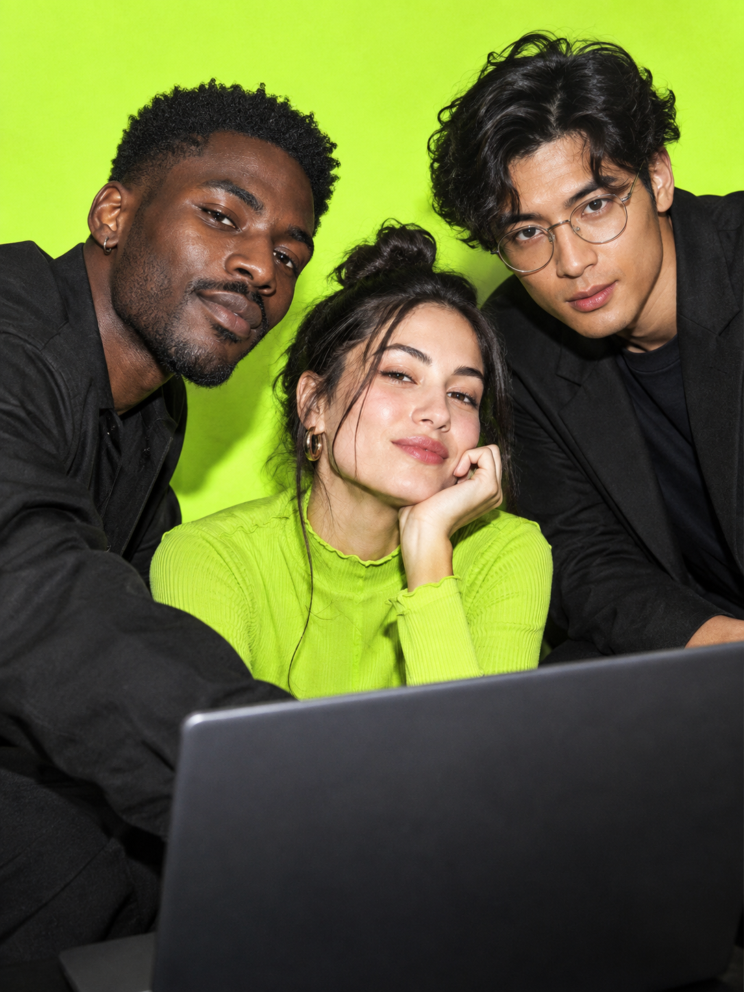 Editorial image of creative professionals collaborating around a laptop